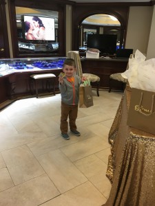 Kid standing with with a gift bag in Roman Jewelers